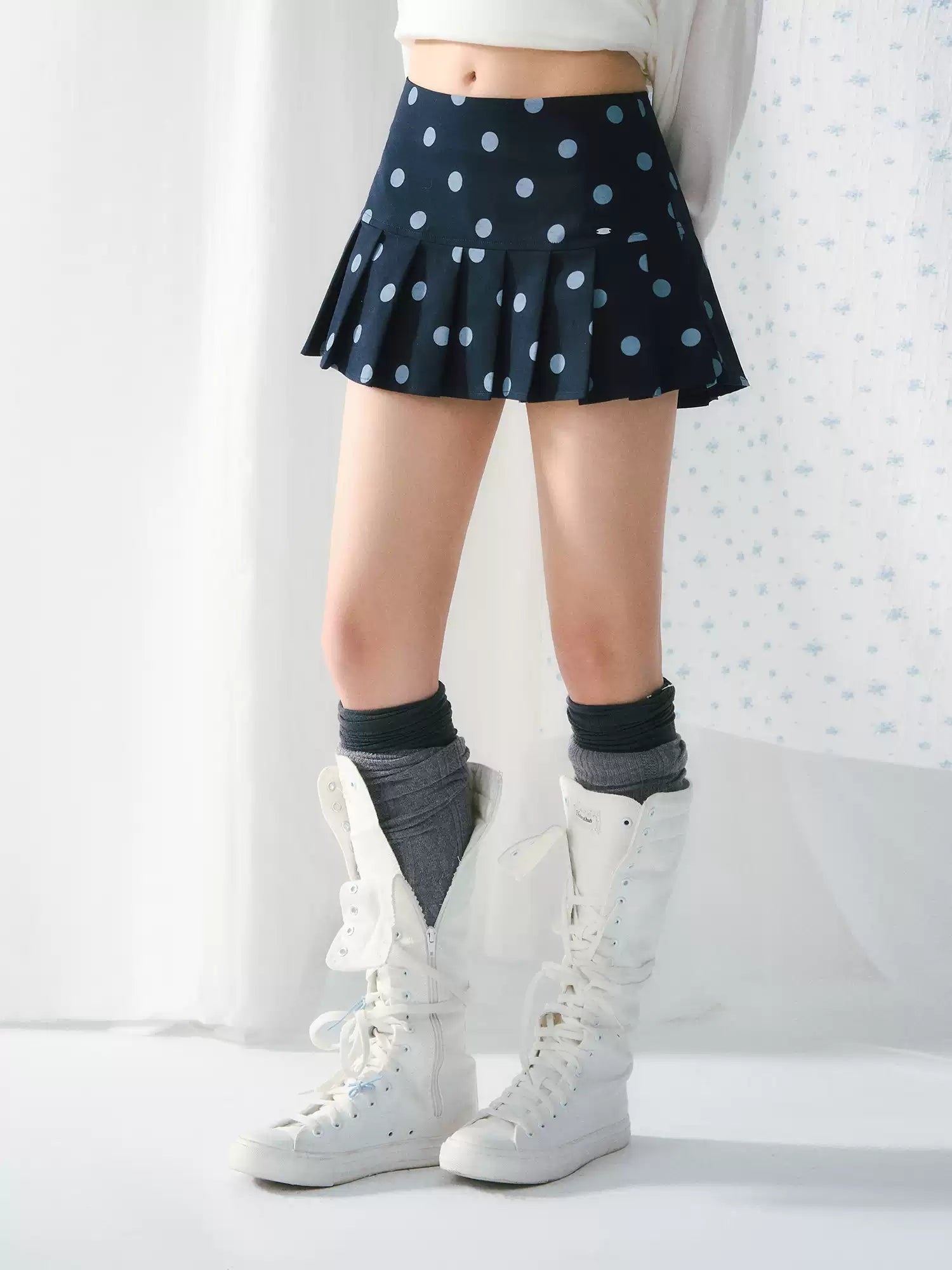 Polka dot pleated A-line mini skirt in navy blue