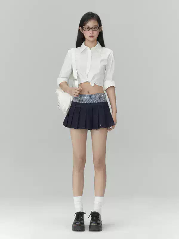 Pleated denim A-line mini skirt in navy blue
